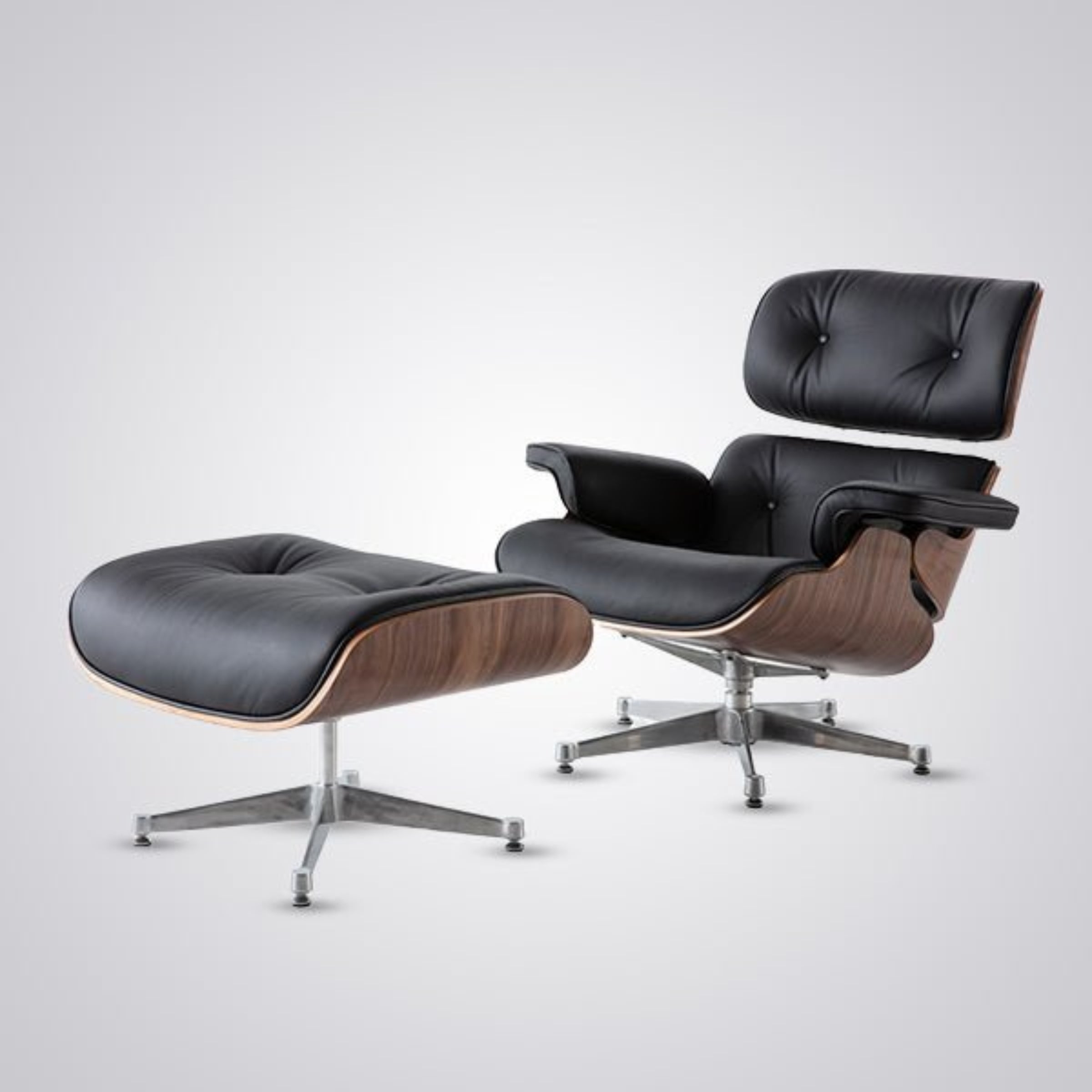 Black leather lounge chair and ottoman on a white background