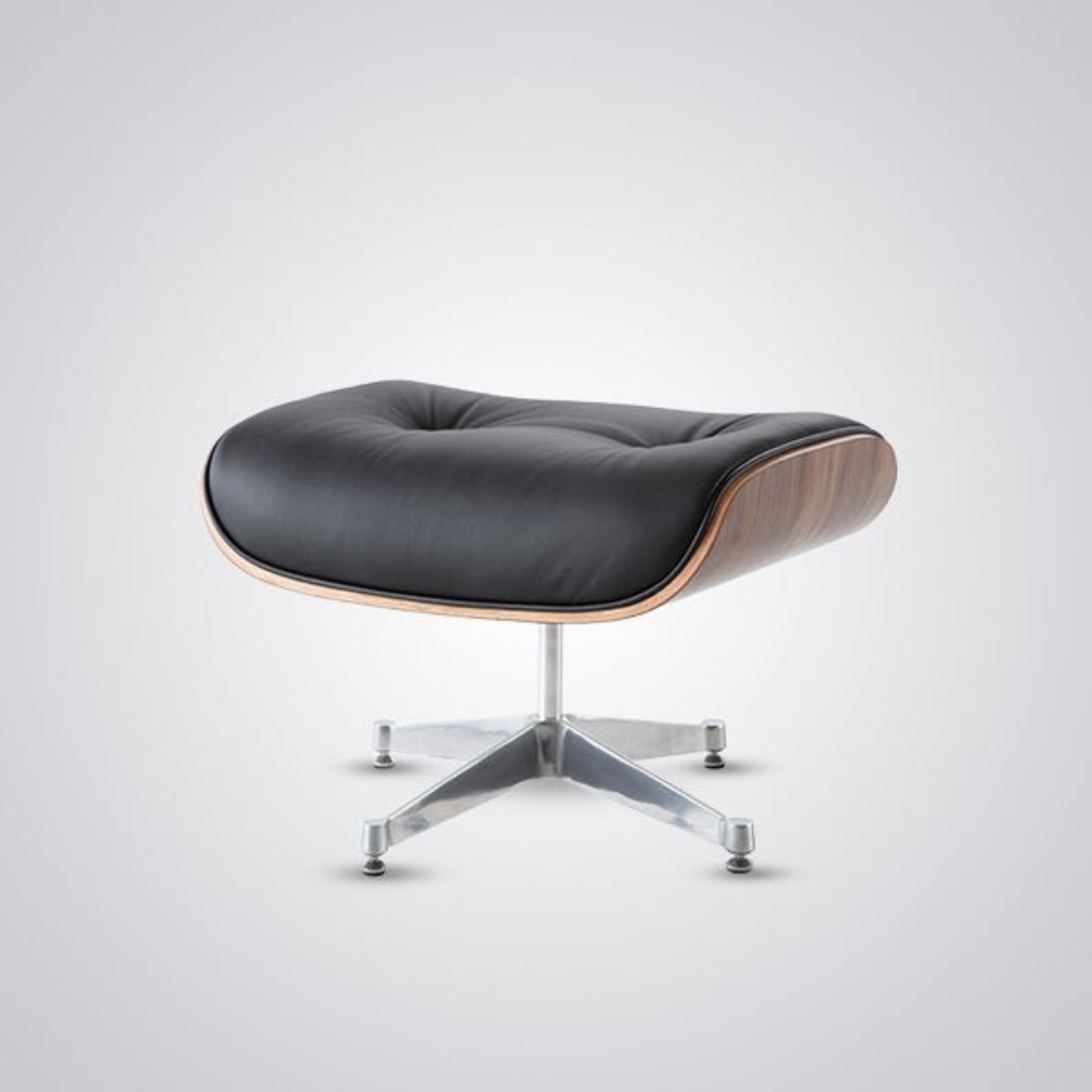 Modern ottoman with black leather seat and wooden accents on a white background