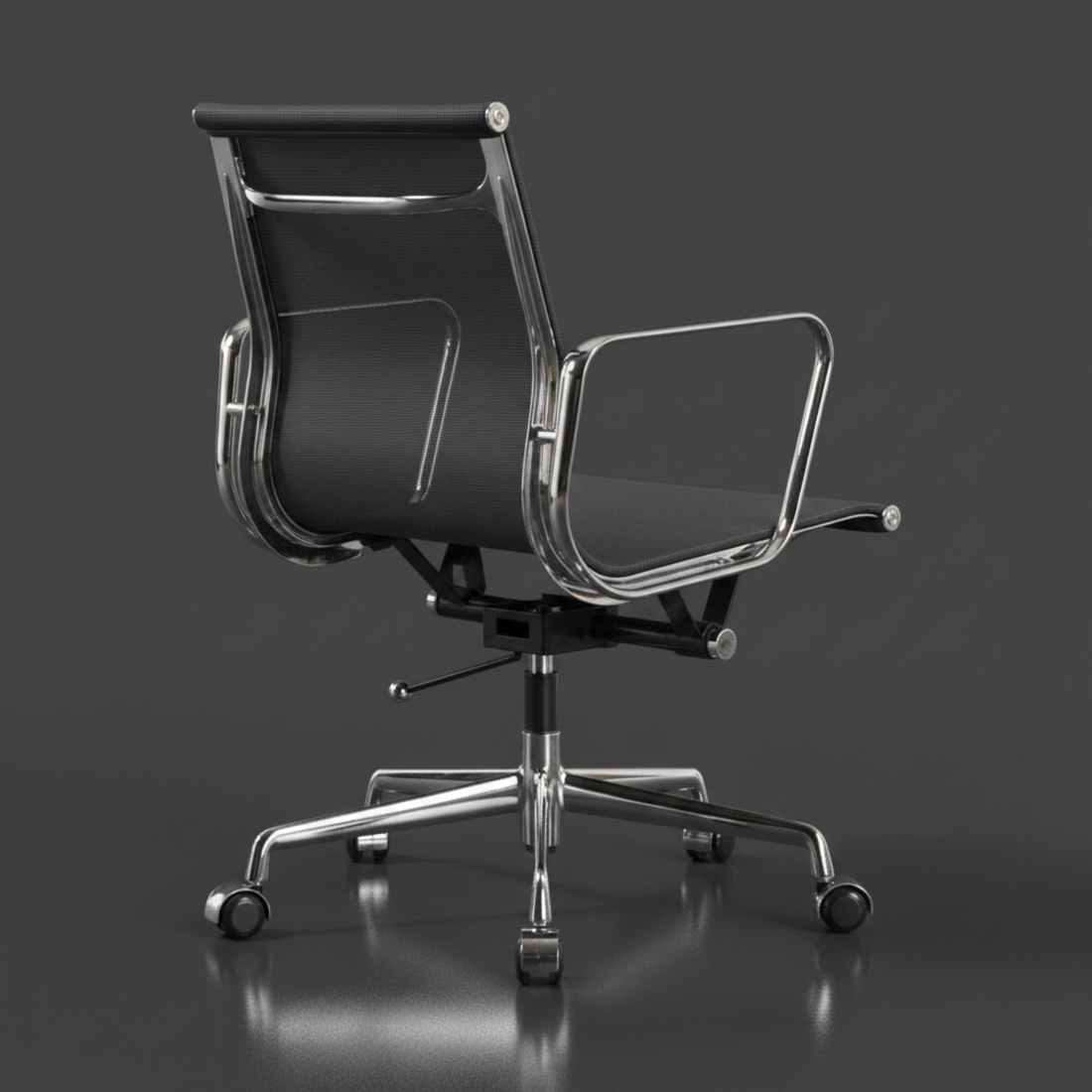 A modern black mesh and upholstered office chair with chrome five-star base and casters, centered against a dark studio background.