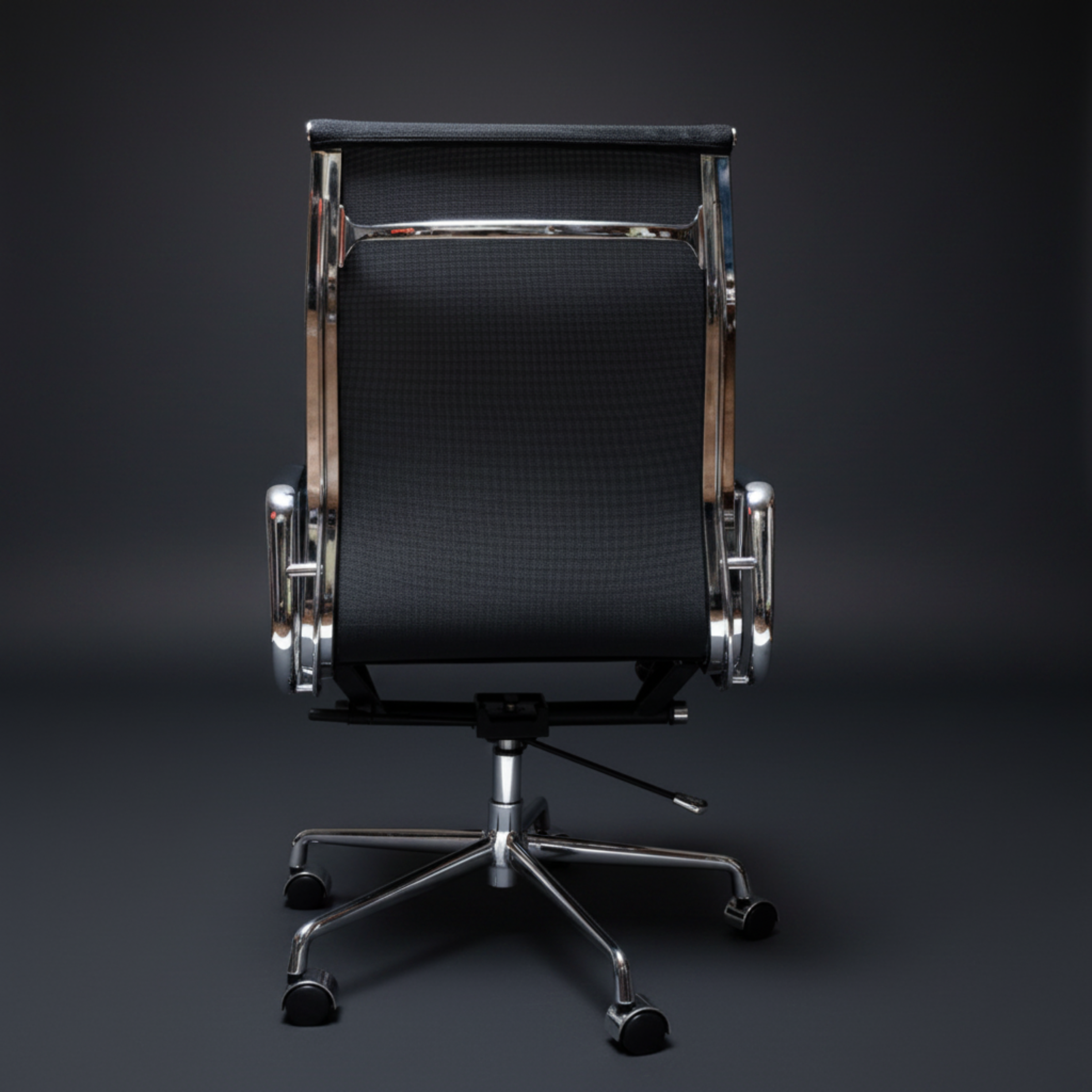 A modern office chair with a black textured mesh backrest, polished chrome metal frame, armrests, and a five-star wheeled base