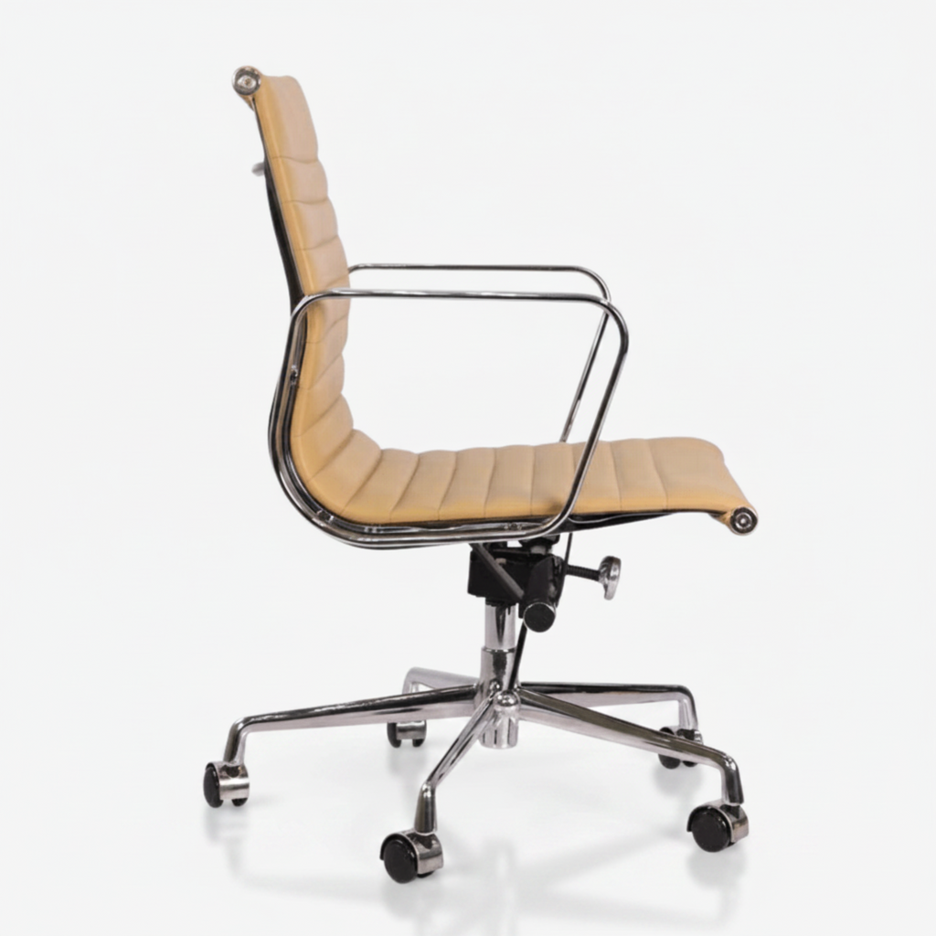 A modern office chair with a curved beige leather seat and backrest, supported by a polished chrome metal frame 