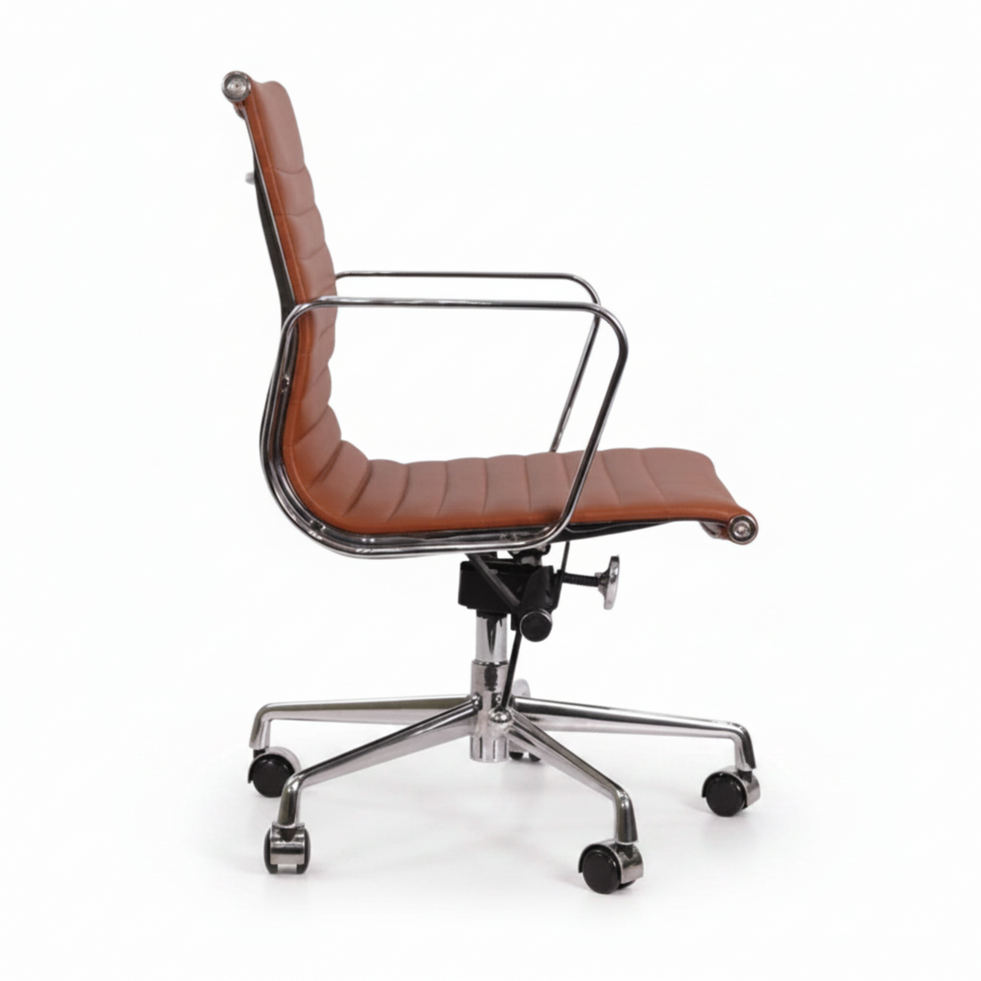 A modern office chair with a curved, ribbed cognac brown faux leather seat and backrest, supported by a chrome-finished metal frame