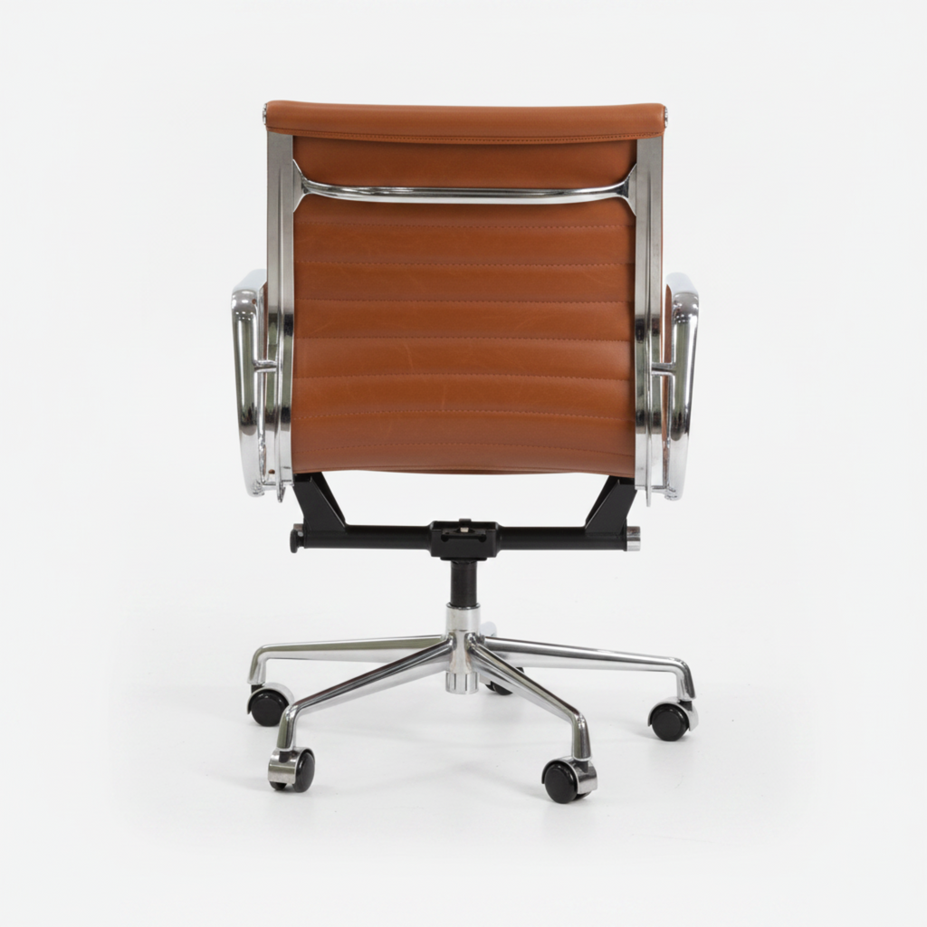 A modern office chair with a brown leather seat and backrest, supported by a polished chrome five-star base with casters